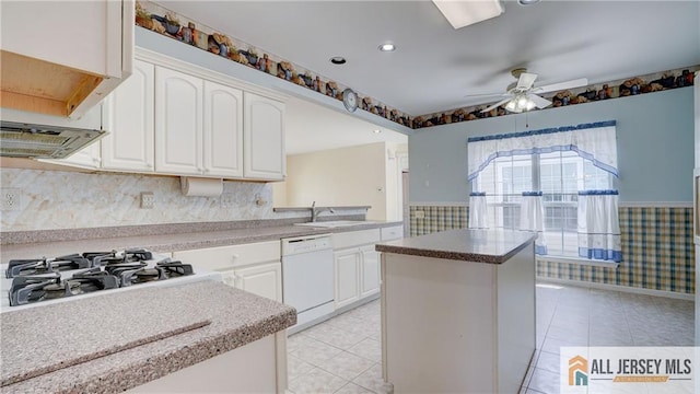 532 Waterside Blvd, Monroe, NJ 08831 - kitchen with white dishwasher, light tile patterned floors, a sink, wainscoting, and a ceiling fan