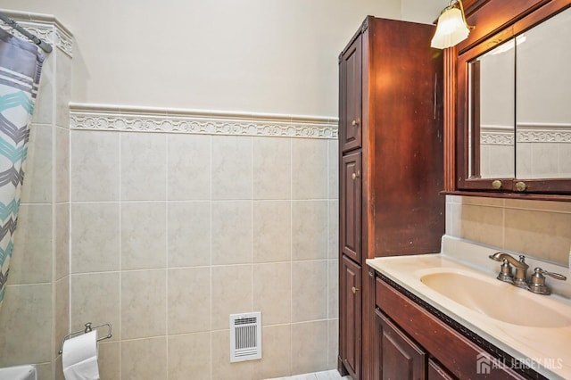 134 Devon Rd, Colonia, NJ 07067 - full bathroom featuring vanity, tile walls, curtained shower, and wainscoting
