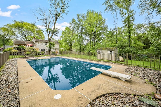 134 Devon Rd, Colonia, NJ 07067 - view of swimming pool featuring a diving board, a fenced backyard, a patio area, and an outbuilding