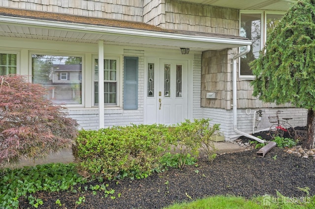 134 Devon Rd, Colonia, NJ 07067 - view of exterior entry with brick siding and a porch