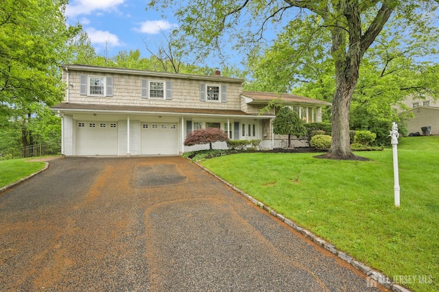 134 Devon Rd, Colonia, NJ 07067 - view of front facade featuring driveway, a garage, a chimney, and covered porch