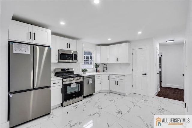 99 Crestview Rd, Fords, NJ 08863 - kitchen featuring stainless steel appliances, white cabinets, light marble finish floors, light countertops, and recessed lighting