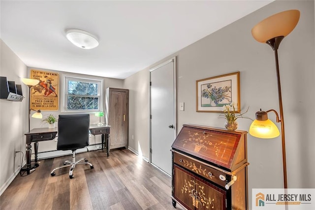 office space featuring baseboards and wood finished floors