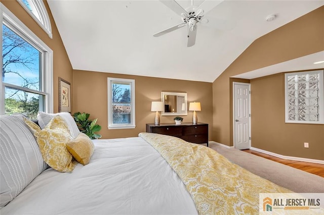 bedroom featuring wood finished floors, ceiling fan, baseboards, and vaulted ceiling