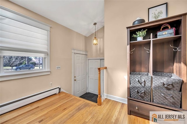 entryway with wood-type flooring, baseboards, lofted ceiling, and baseboard heating
