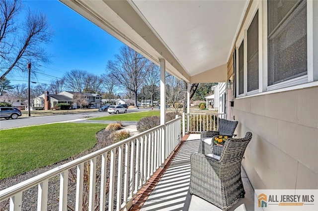 balcony featuring a porch and a residential view