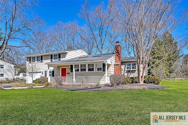 tri-level home with a chimney, a porch, and a front yard