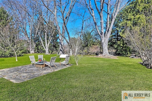 view of yard featuring a fire pit and a patio