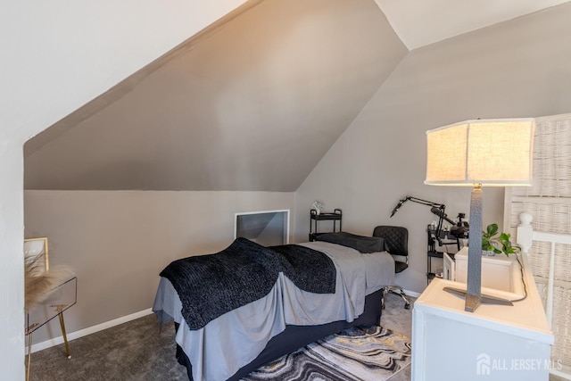 bedroom with lofted ceiling, baseboards, and carpet floors