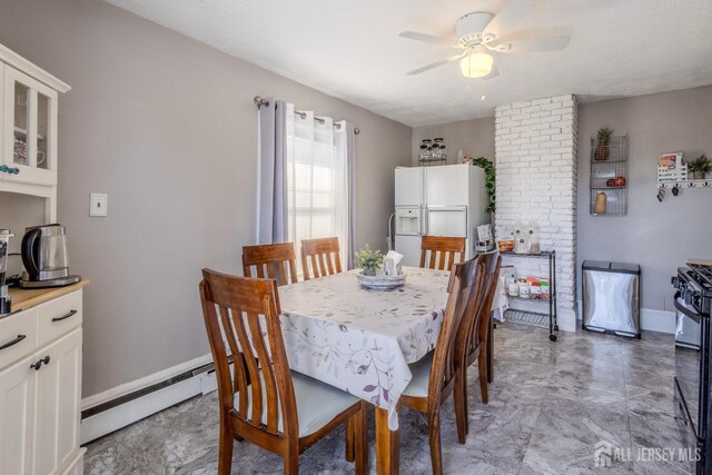 dining room with baseboards, baseboard heating, and ceiling fan