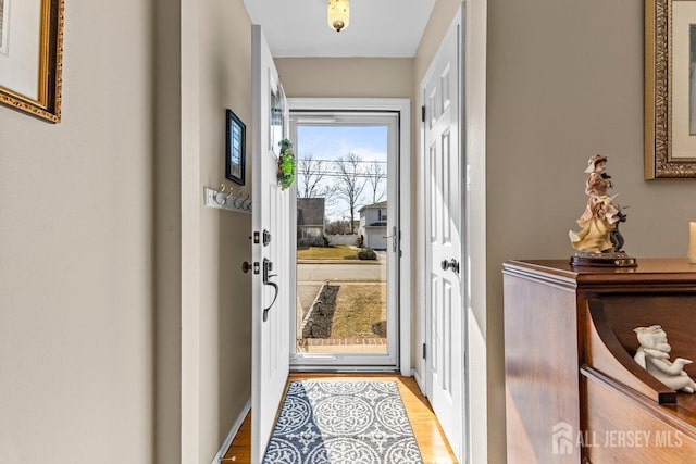 doorway with light wood-style flooring