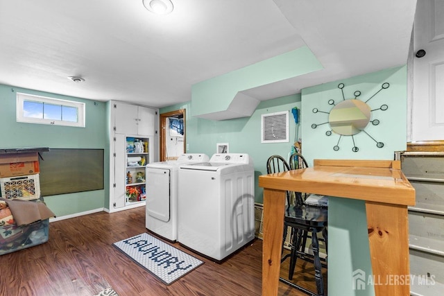 clothes washing area featuring laundry area, baseboards, visible vents, dark wood-type flooring, and independent washer and dryer