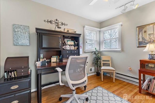 office with baseboards, visible vents, a baseboard radiator, ceiling fan, and wood finished floors