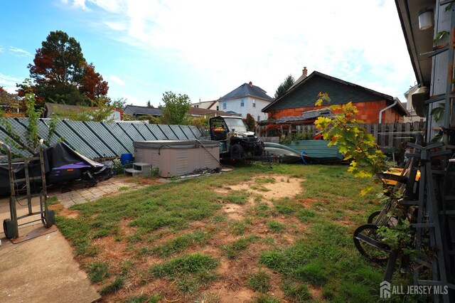 view of yard with a patio area and a hot tub