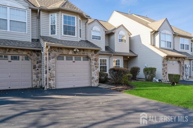 townhome / multi-family property featuring a garage