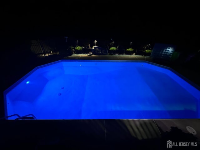 pool at twilight with an outdoor pool