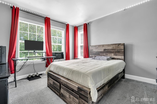 bedroom featuring carpet and baseboards
