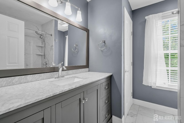 full bath with marble finish flooring, baseboards, a shower, and vanity