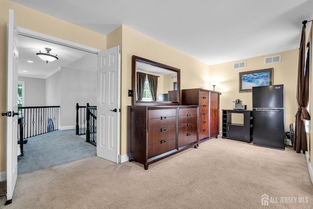 carpeted bedroom featuring freestanding refrigerator and baseboards