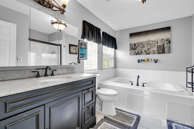 bathroom with a bath, vanity, a stall shower, and toilet
