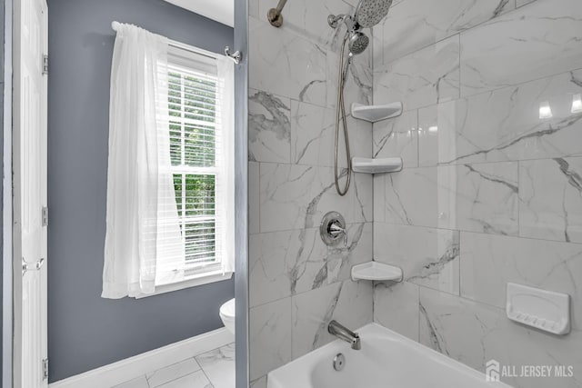 full bathroom featuring baseboards, marble look tile flooring, toilet, and  shower combination