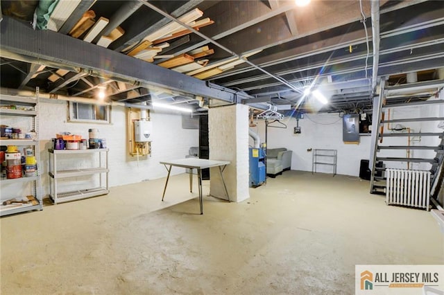 basement featuring electric panel and water heater