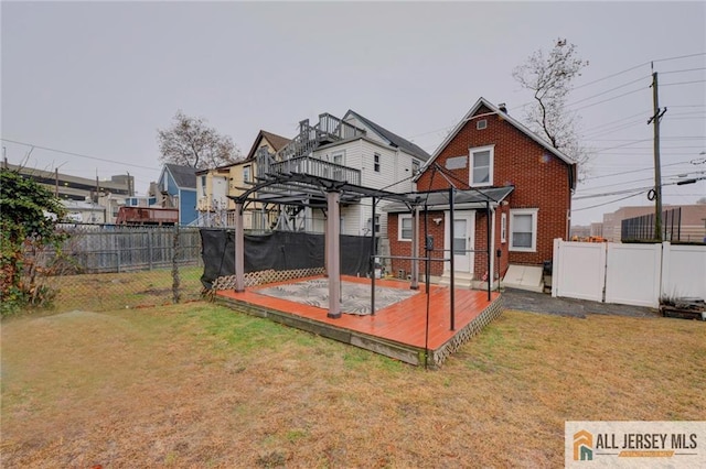 back of property featuring a pergola and a lawn