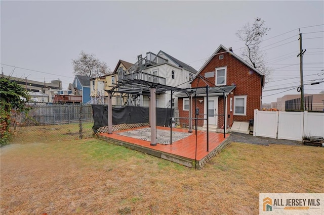 rear view of house featuring a yard and a pergola