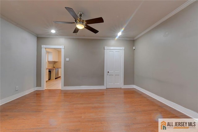 empty room with crown molding, ceiling fan, and light wood-type flooring