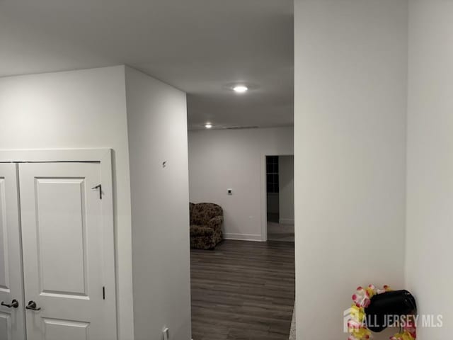 hall featuring dark wood finished floors and baseboards