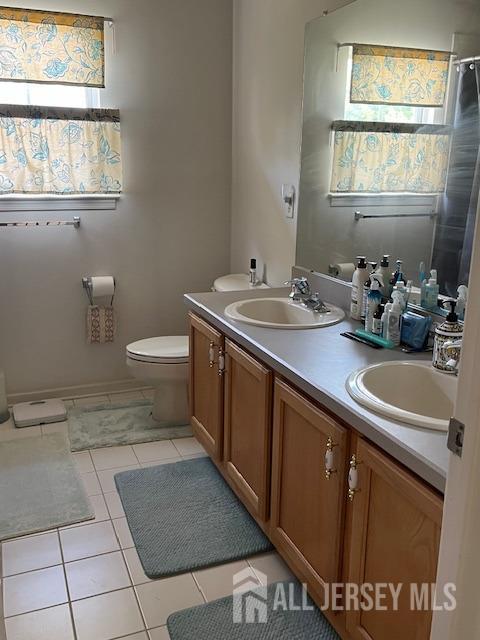11 Pebble Beach Ct, Monroe, NJ 08831 - full bathroom with double vanity, a sink, tile patterned flooring, and toilet