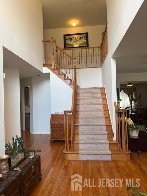 11 Pebble Beach Ct, Monroe, NJ 08831 - stairway with wood finished floors and a towering ceiling