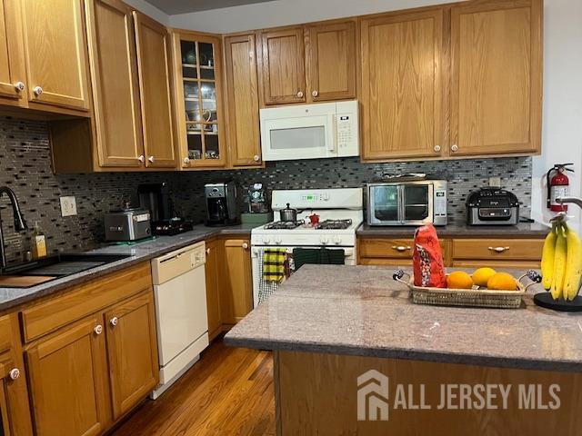 11 Pebble Beach Ct, Monroe, NJ 08831 - kitchen with decorative backsplash, a toaster, white appliances, glass insert cabinets, and a sink
