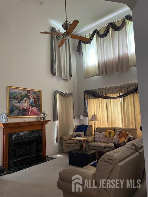 11 Pebble Beach Ct, Monroe, NJ 08831 - living room with carpet floors, a premium fireplace, and a ceiling fan