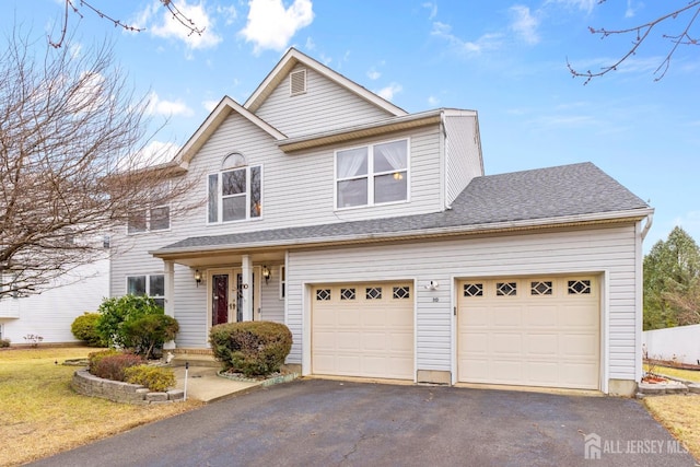 view of front facade featuring aphalt driveway and a shingled roof