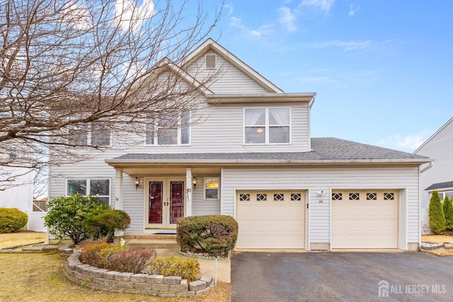 view of front of property with french doors, a garage, a shingled roof, and aphalt driveway