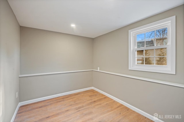 spare room with light wood-type flooring and baseboards