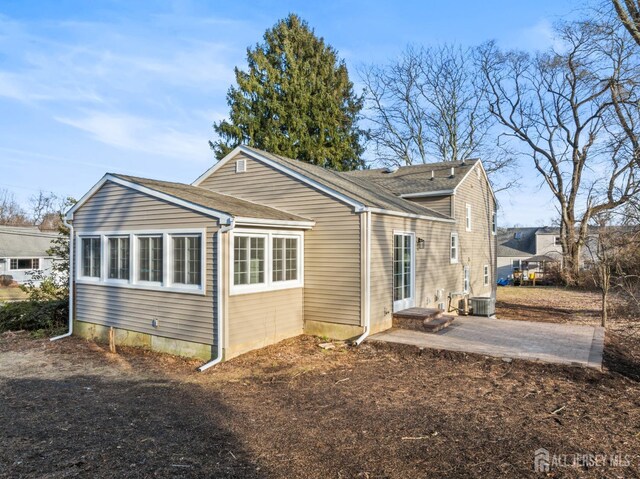 view of side of property with a patio and cooling unit