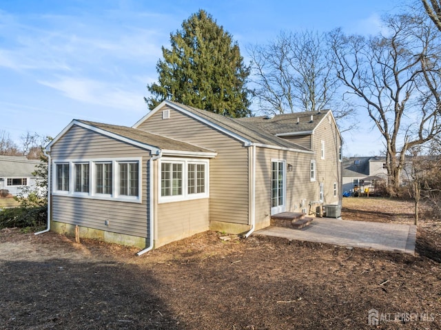 rear view of house featuring a patio and cooling unit