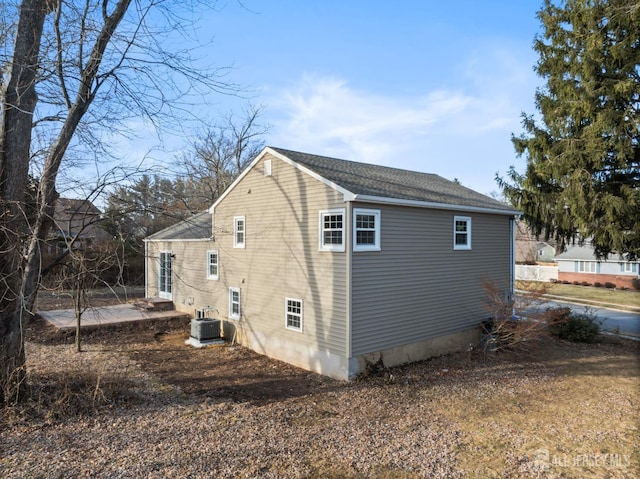 view of side of home with a patio and cooling unit