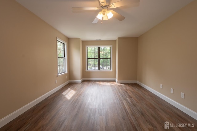 2708 Ridgefield Ct, Helmetta, NJ 08828 - unfurnished room featuring dark wood-type flooring, baseboards, and ceiling fan