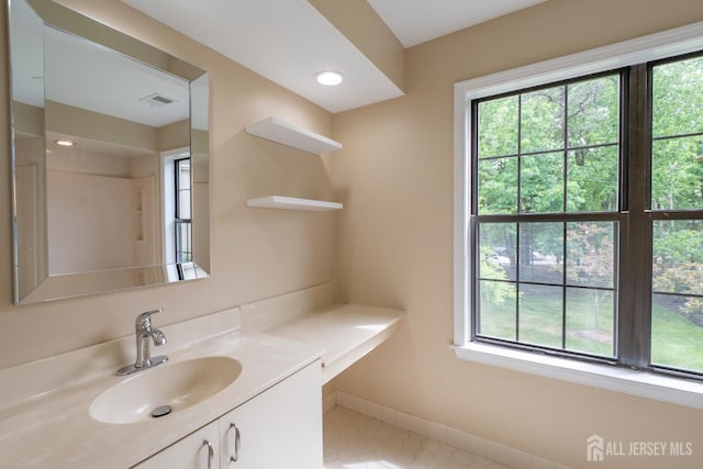2708 Ridgefield Ct, Helmetta, NJ 08828 - bathroom featuring plenty of natural light, vanity, and tile patterned flooring