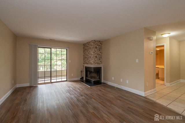 2708 Ridgefield Ct, Helmetta, NJ 08828 - unfurnished living room featuring wood finished floors, a fireplace, and baseboards