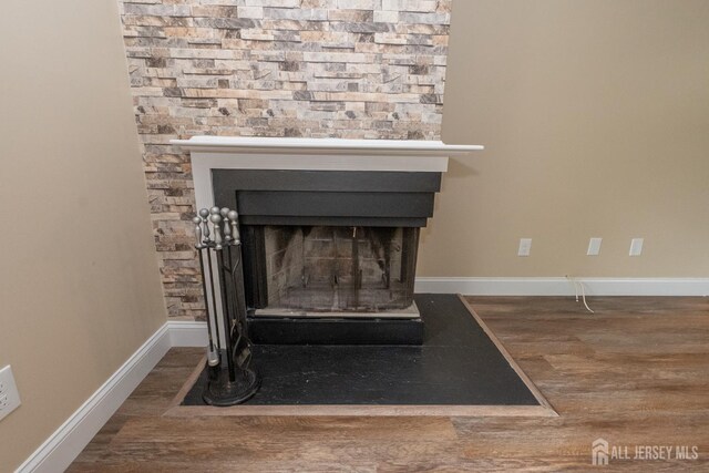 2708 Ridgefield Ct, Helmetta, NJ 08828 - detailed view of wood finished floors, baseboards, and a fireplace with flush hearth
