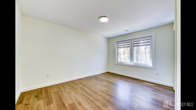 spare room featuring light wood-type flooring