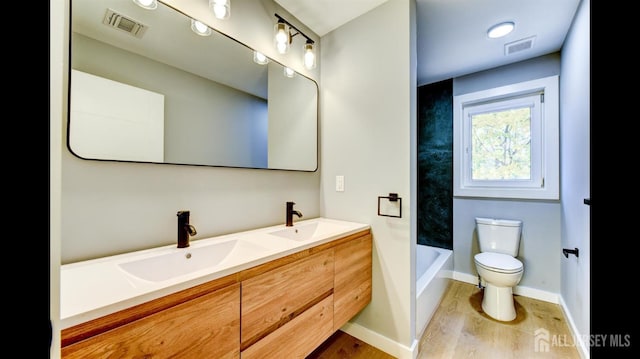 bathroom featuring hardwood / wood-style flooring, vanity, and toilet