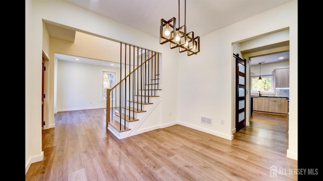 interior space featuring wood-type flooring and a chandelier