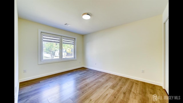 empty room with light hardwood / wood-style flooring