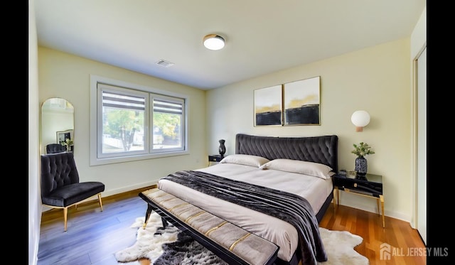 bedroom with hardwood / wood-style floors