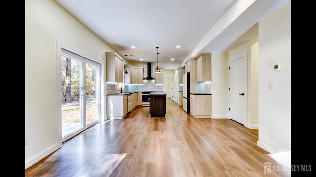 kitchen with wall chimney exhaust hood, a center island, white fridge, pendant lighting, and decorative backsplash